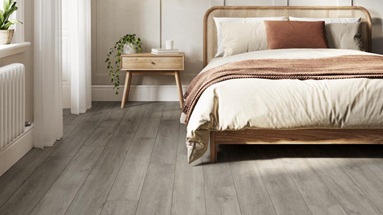 Plank vinyl flooring in a neutral scheme bedroom