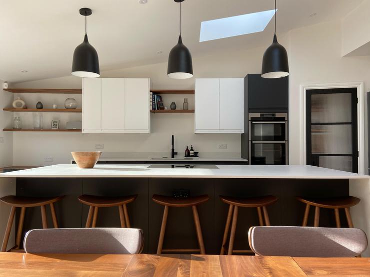 Charcoal kitchen island with white worktop and wall units