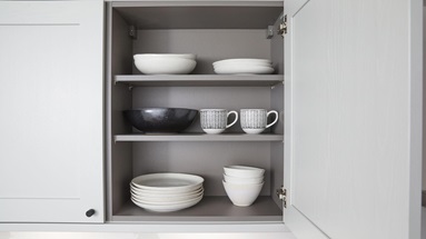 A grey kitchen makeover featuring shaker doors, black handles. Includes croft-grey units for a modern look and bespoke shelving.