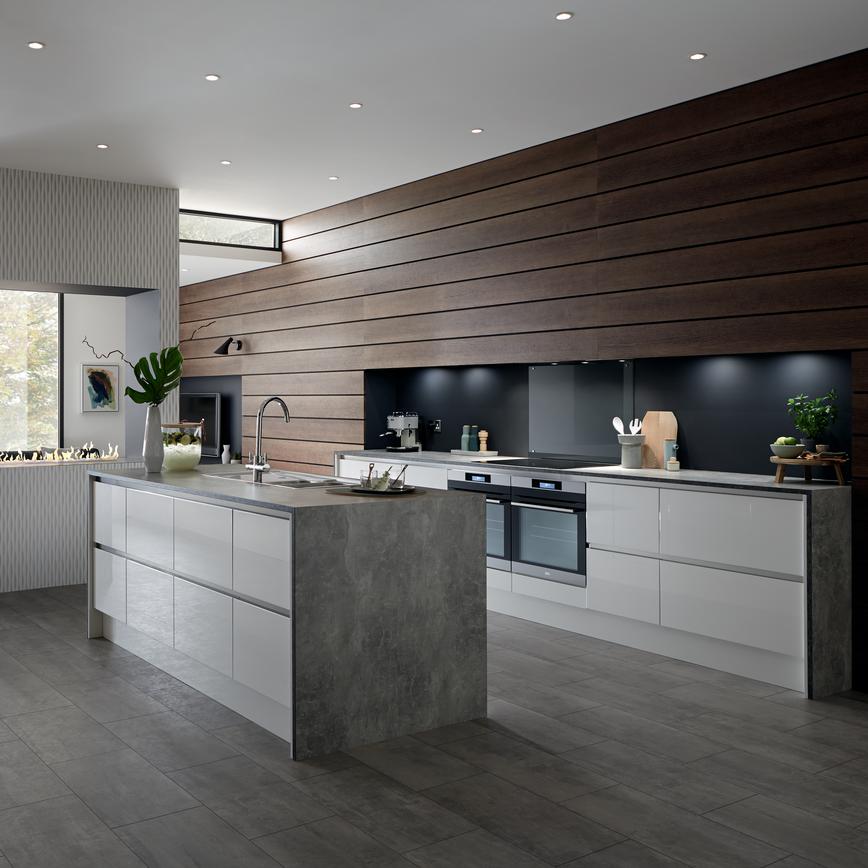 A kitchen extension idea using an open-plan layout and a white gloss kitchen with a handleless design