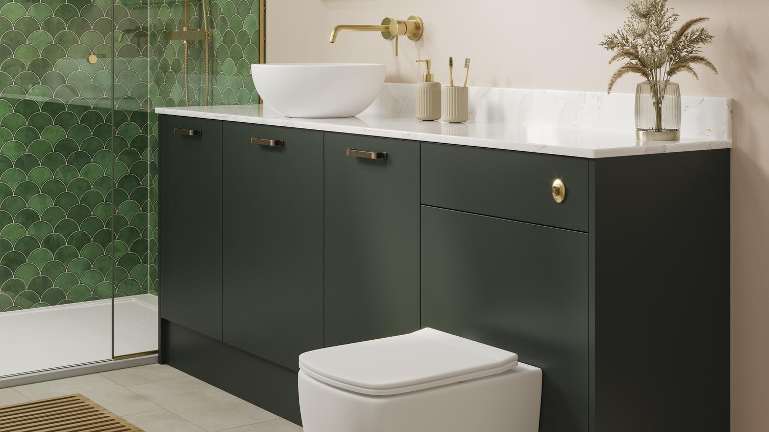 A Hockley green bathroom with dark cabinets & sink with gold accessories. Inside are toilet, sink, & tiled flooring.