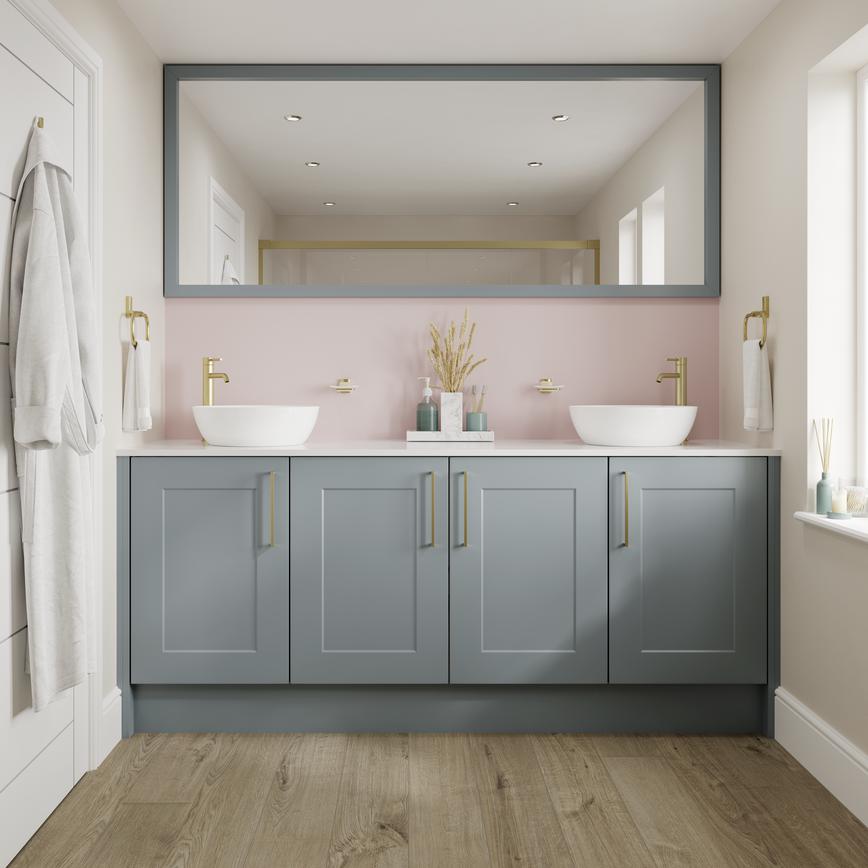 Small shaker bathroom with dusk-blue cupboard doors. Has a white worktop, oak floors, and brass handles for a luxe touch.