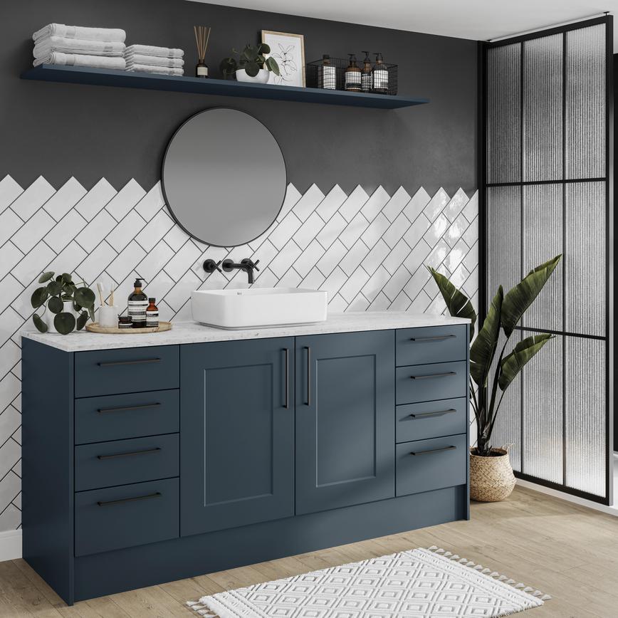 A marine blue bathroom with shaker cupboards in a single wall layout. Includes black bar handles for a sleek, statement look.
