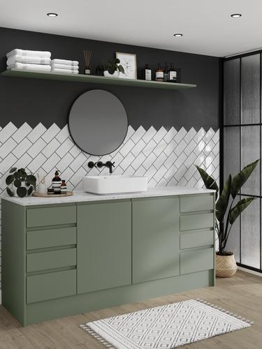 A Clerkenwell bathroom with green cabinets, marble worktop, and black accessories. Also features grey oak flooring.