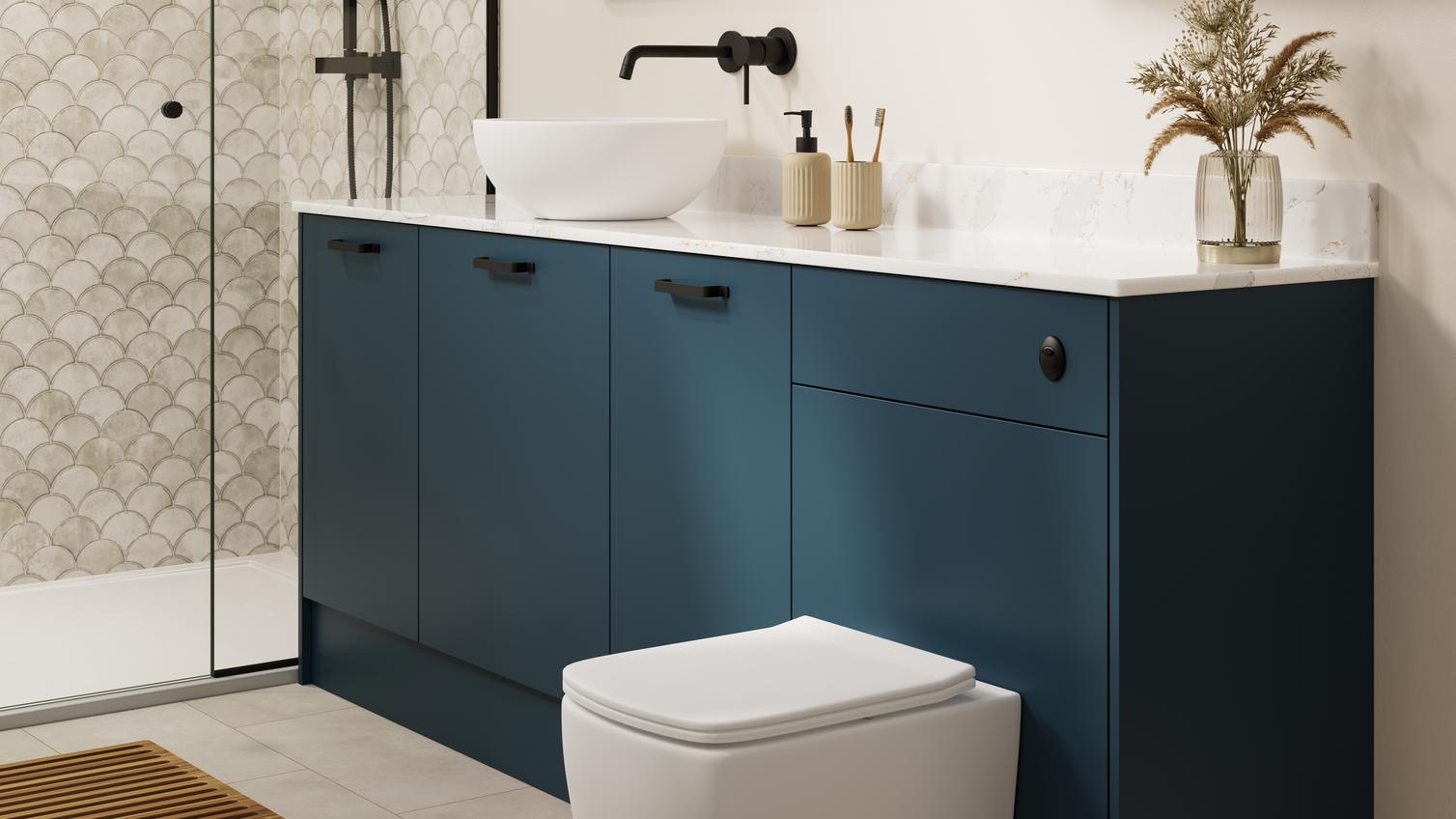 A marine blue bathroom with white countertop and matching upstand. There is a white toilet, shower, and grey tiled flooring.