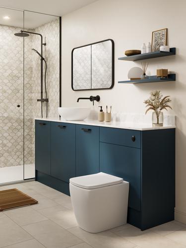 A marine blue bathroom with white countertop and matching upstand. There is a white toilet, shower, and grey tiled flooring.