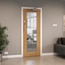 Pre-finished Dordogne Oak Glazed FD30 door in an office