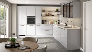 A dove grey, modern kitchen from the Winterton collection. It has a gloss finish, an l-shaped layout and grey, chevron flooring.