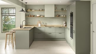 A modern shaker kitchen from the Frome collection in a reed green tone. It has white, tile flooring and a u-shaped layout.