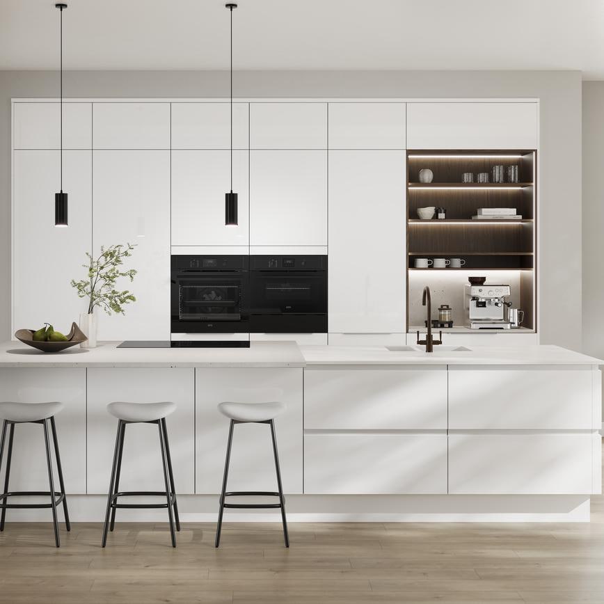 A white, modern kitchen from the Winterton collection. It has an island layout, gloss finish, and matching white worktop.