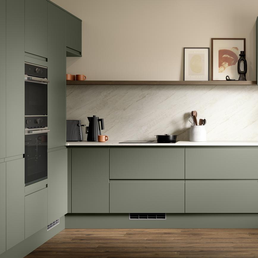 A modern dark ash green kitchen with integrated handles. It is in an l-shape layout with white stone worktops and back panel. 