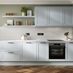 A pale mist-blue shaker kitchen in a single-wall layout. It has matching wall cabinets and dark oak herringbone flooring.