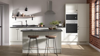 A shaker kitchen in a light white colour and single-wall layout. There are dark stone worktops and matching breakfast bar.