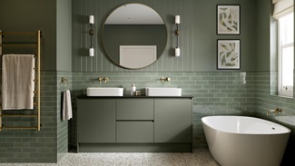 An ash green-coloured bathroom, with super matt door and drawer fronts. It has matching wall tiles & stone-effect flooring.
