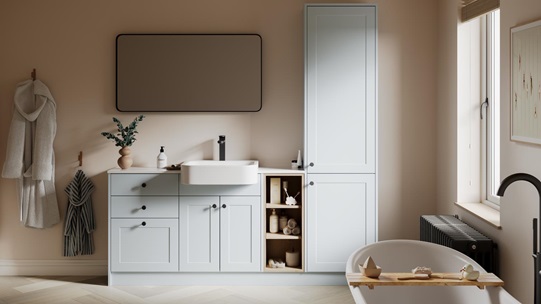 A mist-blue bathroom with shaker vanity unit & matching tall storage cabinet. It has white fittings with black accessories. 