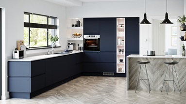 A sophisticated blue kitchen idea with integrated handle doors, white worktops, and chevron floors in a peninsular layout.