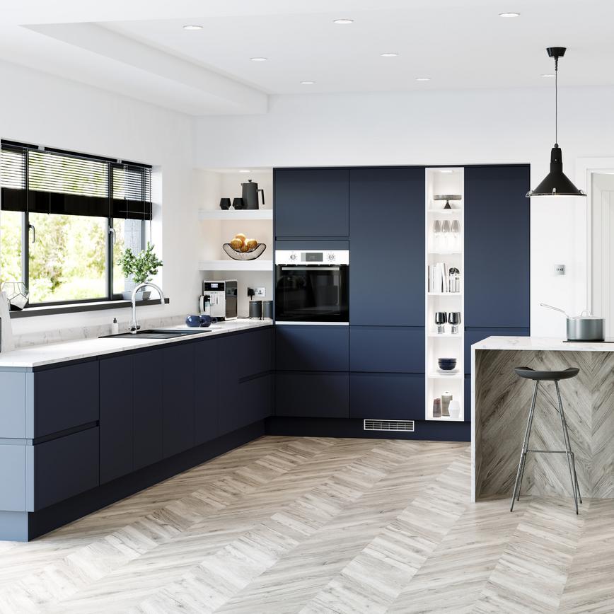 Navy blue handleless super matt kitchen in l shape layout with marble worktop and full height built in open shelving.