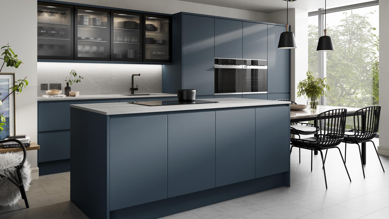 Contemporary marine blue kitchen in an island layout with a matt finish. Includes a grey worktop and black glass wall units.