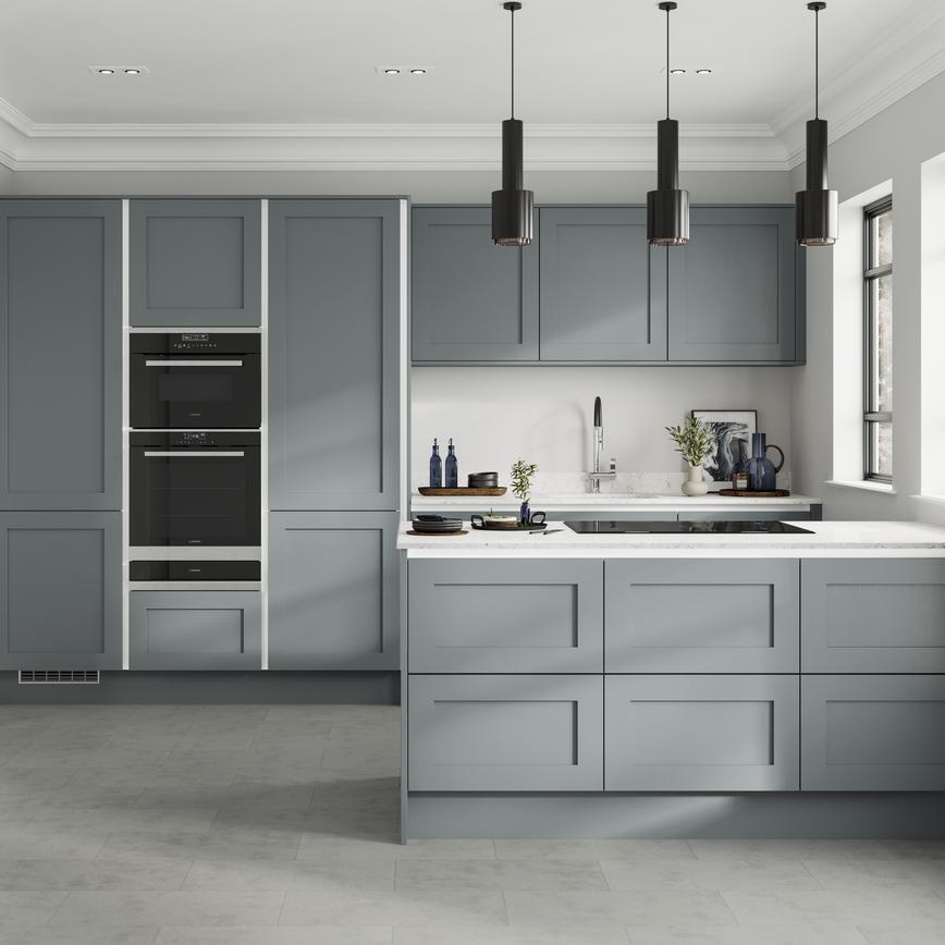 Handleless dusk-blue shaker kitchen with white trims in a peninsula layout. Contains double drawer units and grey floors