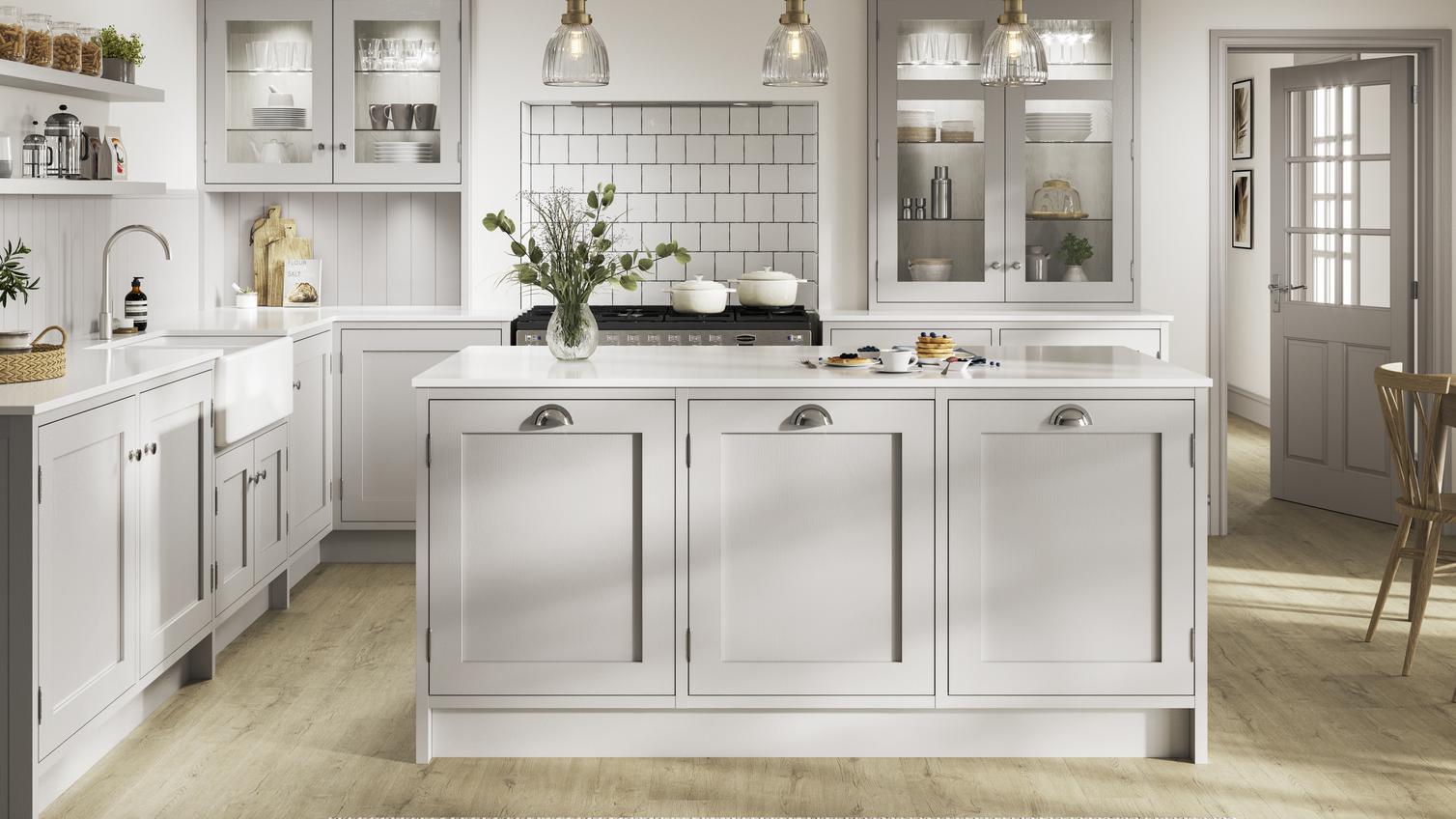 Grey shaker kitchen with an in-frame design in an island layout. Contains exposed hinges, chrome handles, and white worktops