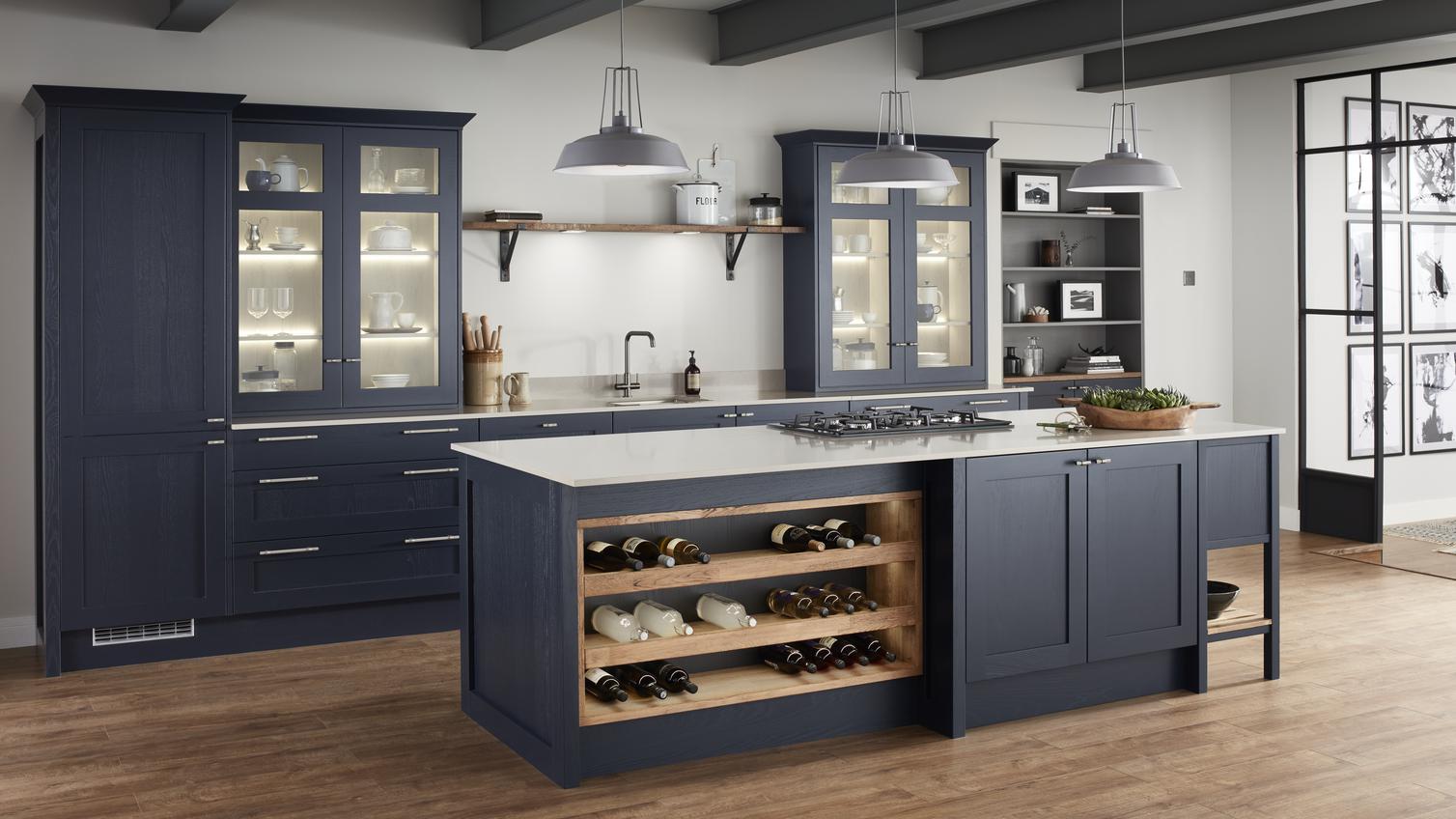 Solid timber framed shaker kitchen in navy blue with island unit, wine rack and worktop mounted glass display cabinets.