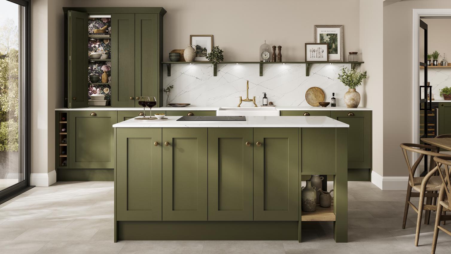 An olive green kitchen in an island layout with white worktops throughout, matching backboard and integrated hob.