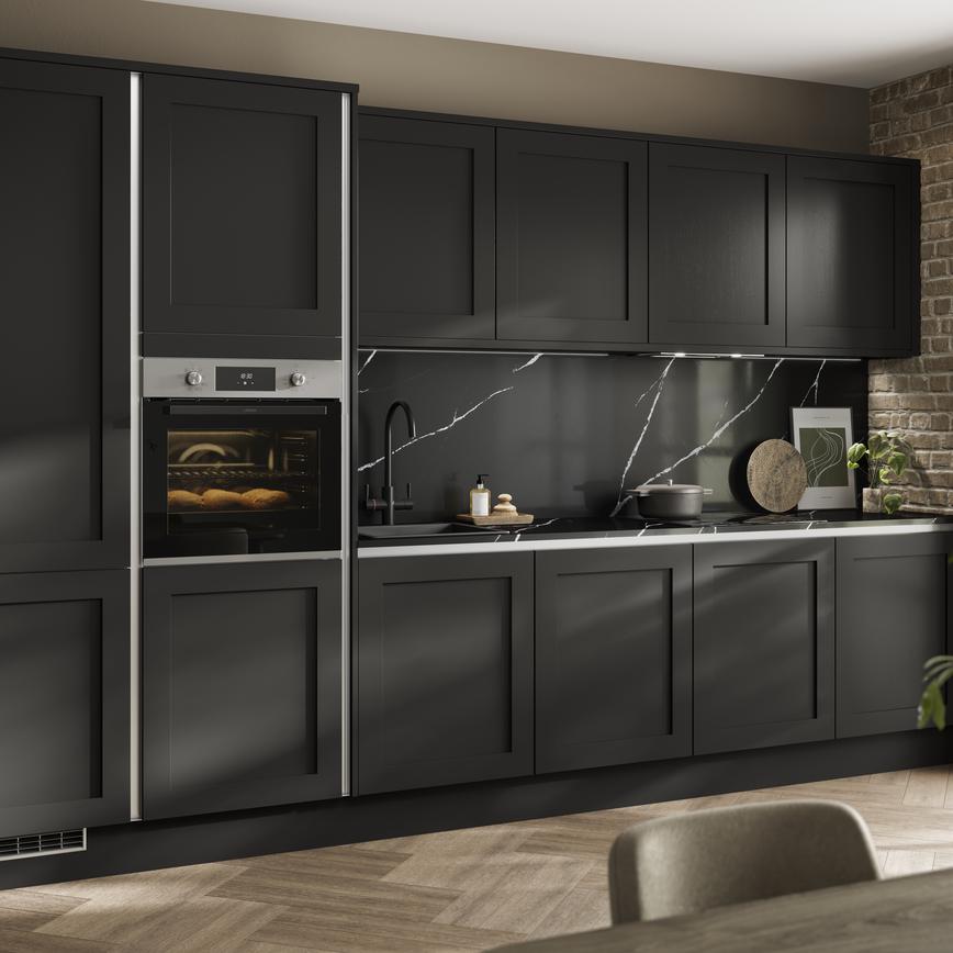 Modern black shaker kitchen featuring handleless doors in a single-wall layout, with a matching black worktop and splashback.