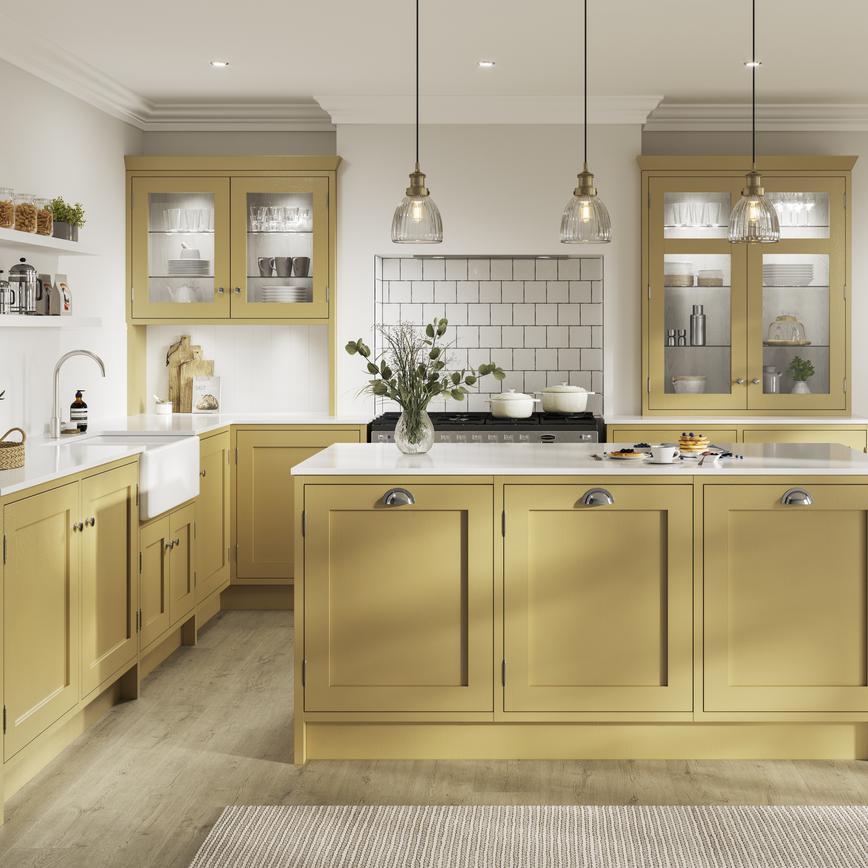 Yellow L-shaped kitchen. Includes timber shaker kitchen doors with in-frame profiles, white worktops, and chrome cup handles.