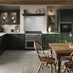 A dark, fir green shaker kitchen in an L-shaped layout. It has glass wall cabinets, tile flooring, and a Range cooker.