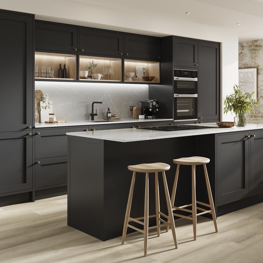 Black matt kitchen with an island layout and in-frame cabinets. Includes white worktops and black tap for a two-tone design.