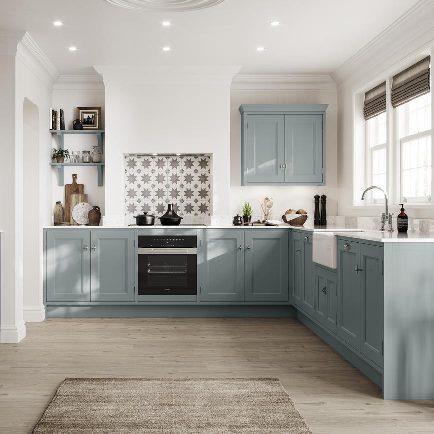 Painted shaker kitchen with in-frame profiles in an L-shaped layout. Includes white worktops, chrome handles, and white sink.