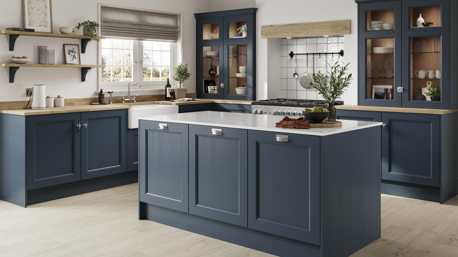 A dark, marine blue shaker kitchen in an L-shaped layout with wood-style worktops. The matching island has white worktops