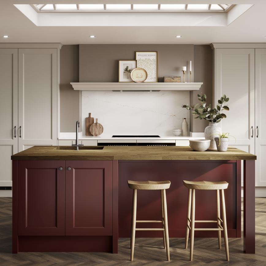 Cream shaker kitchen in an L-shaped layout, with garnet red island and chevron floors. The island has a wood-effect worktop. 
