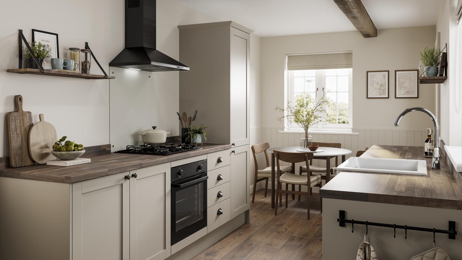 A rustic kitchen in a galley layout. Contains cream, shaker cupboards, dark-wood worktops, and a black, built-under oven.