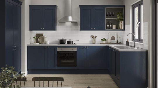A navy kitchen in an L-shaped layout with shaker cabinets. Includes pale wood floors, grey worktops, and a chimney extractor.