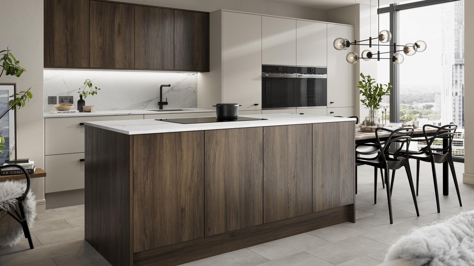 Kitchen island layout with walnut & sandstone slab doors. Has a black induction hob & thin worktops for a contemporary feel. 