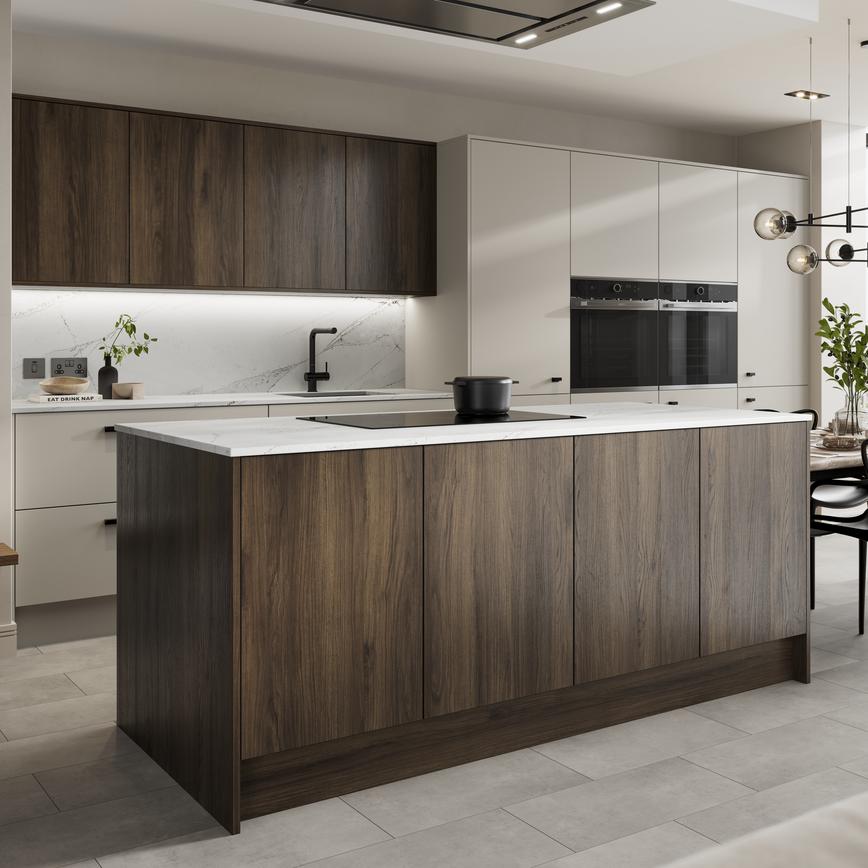 Kitchen island layout with walnut & sandstone slab doors. Has a black induction hob & thin worktops for a contemporary feel. 