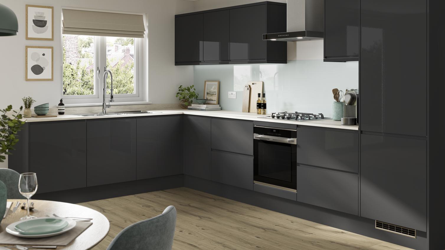A statement charcoal kitchen design with integrated handle doors, a white worktop, and black and chrome cooking devices.