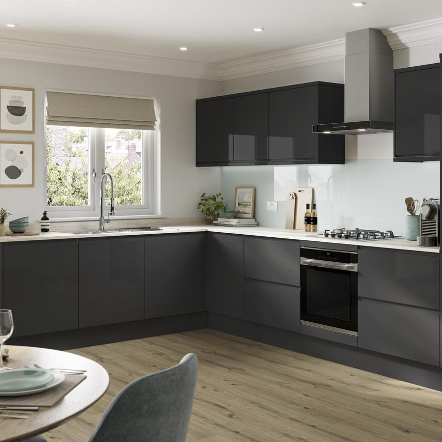 A statement charcoal kitchen design with integrated handle doors, a white worktop, and black and chrome cooking devices.