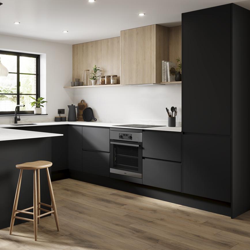 A black kitchen in a U-shaped layout with integrated handle cupboards. Includes white, marble-effect worktops and oak floors.