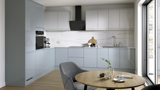 A blue kitchen from Clerkenwell Mist, in an l-shaped layout. It has a gloss finish, white wall cabinets & marble backboard.