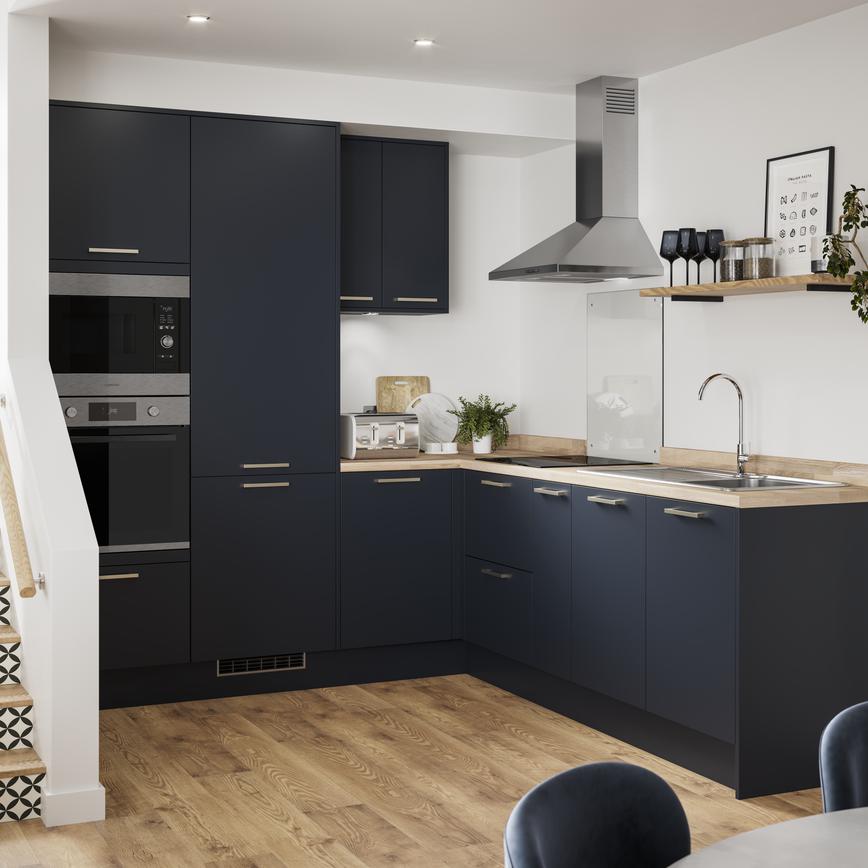 L-shaped compact kitchen layout with navy kitchen doors, wood worktops and wood flooring. Has open shelving and wall units.