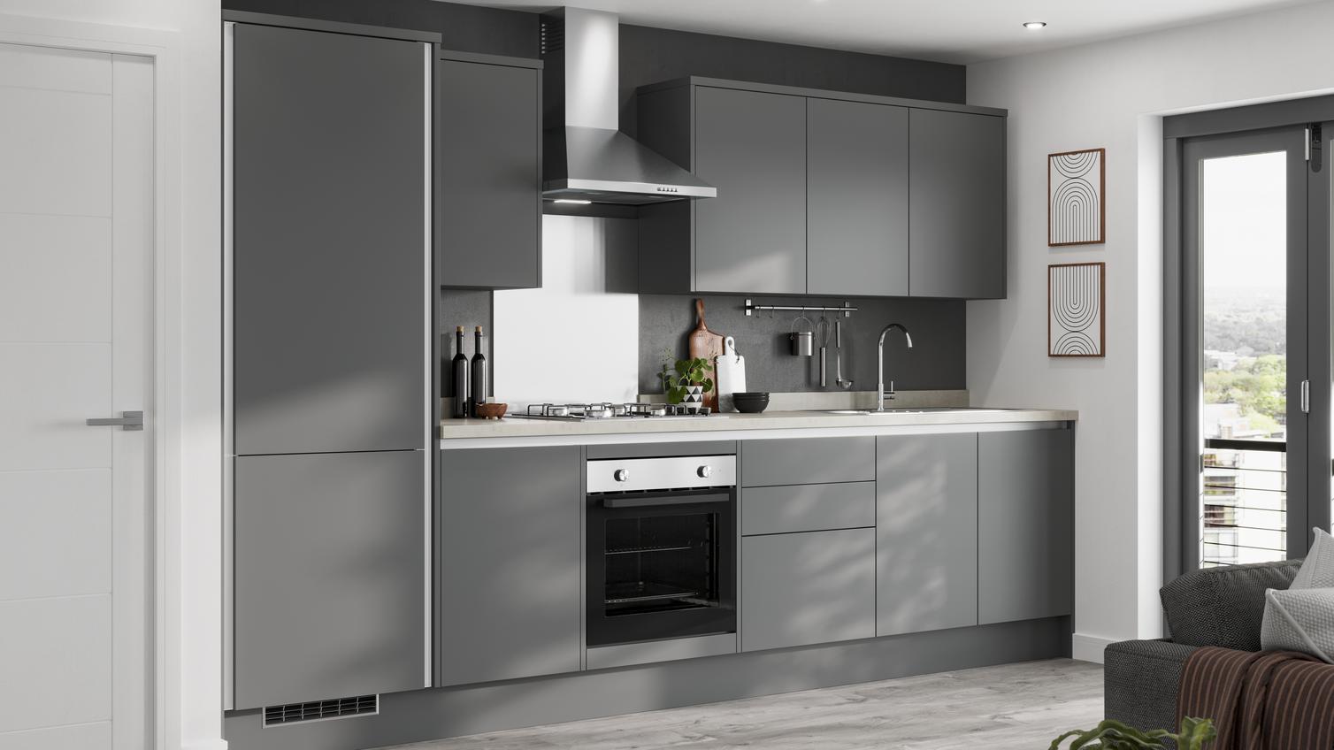 A contemporary grey handleless kitchen in a single wall layout with silver profiles, slab cupboards, and pale wood worktops.