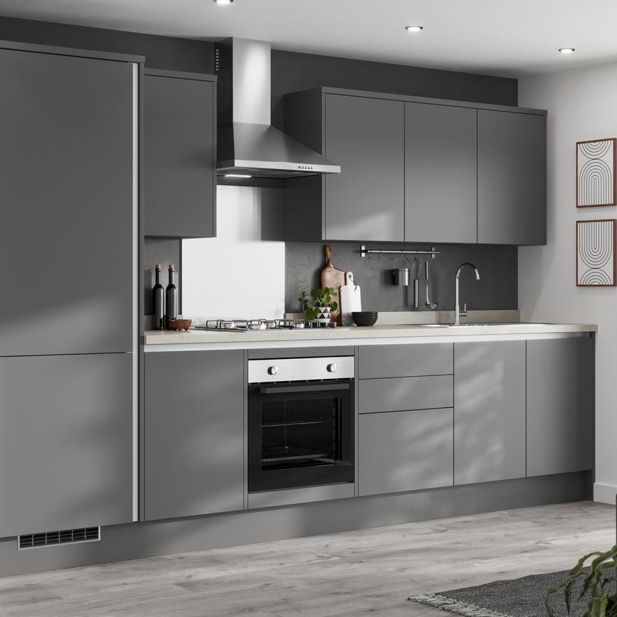 A contemporary grey handleless kitchen in a single wall layout with silver profiles, slab cupboards, and pale wood worktops.