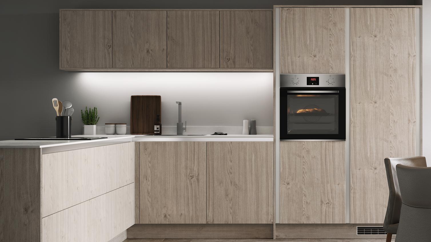 Light grey oak handleless kitchen in an l shape with wall cabinets along a single wall, white worktop and built in oven.