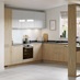 Natural oak u shape kitchen with integrated breakfast bar, black kitchen worktop and contrasting gloss white wall units.