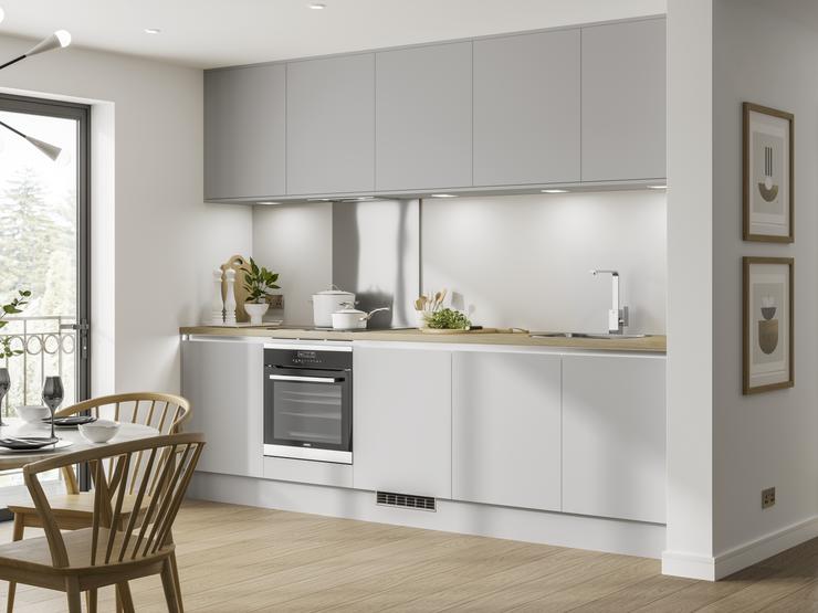 Handleless kitchen in grey with a matt finish with built under electric oven shown in a single wall kitchen layout.