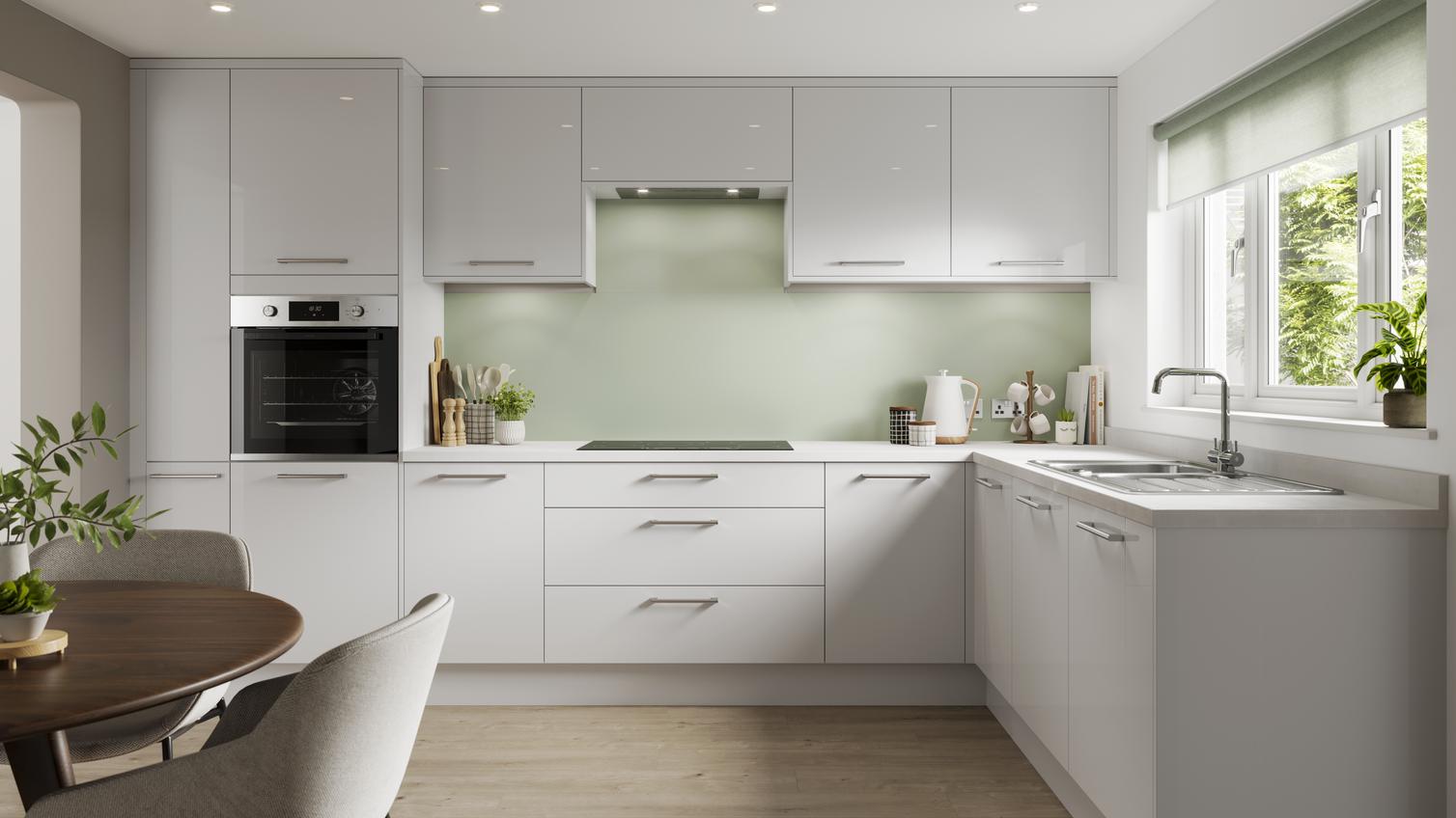 A dove grey kitchen in a gloss finish and in an L-shaped layout. It has integrated appliances and light-oak flooring.