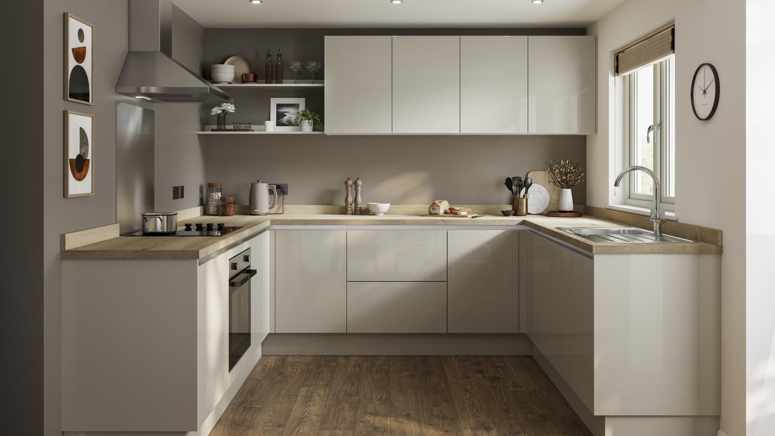 A minimal sandstone kitchen design with integrated handle doors, a warm wood worktop and floors, and chrome cooking devices