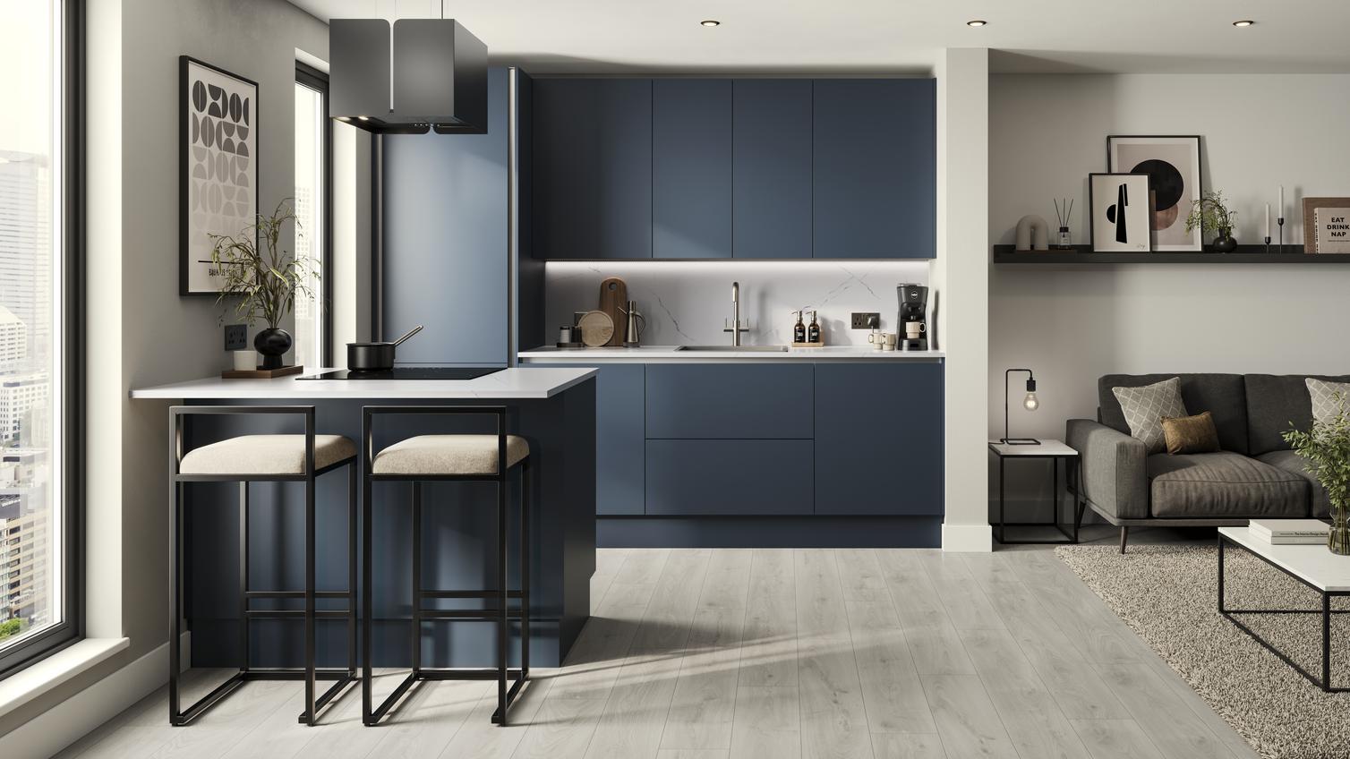 A marine blue kitchen with handleless cabinet doors. It is in a one-wall layout with a breakfast bar and grey oak flooring.